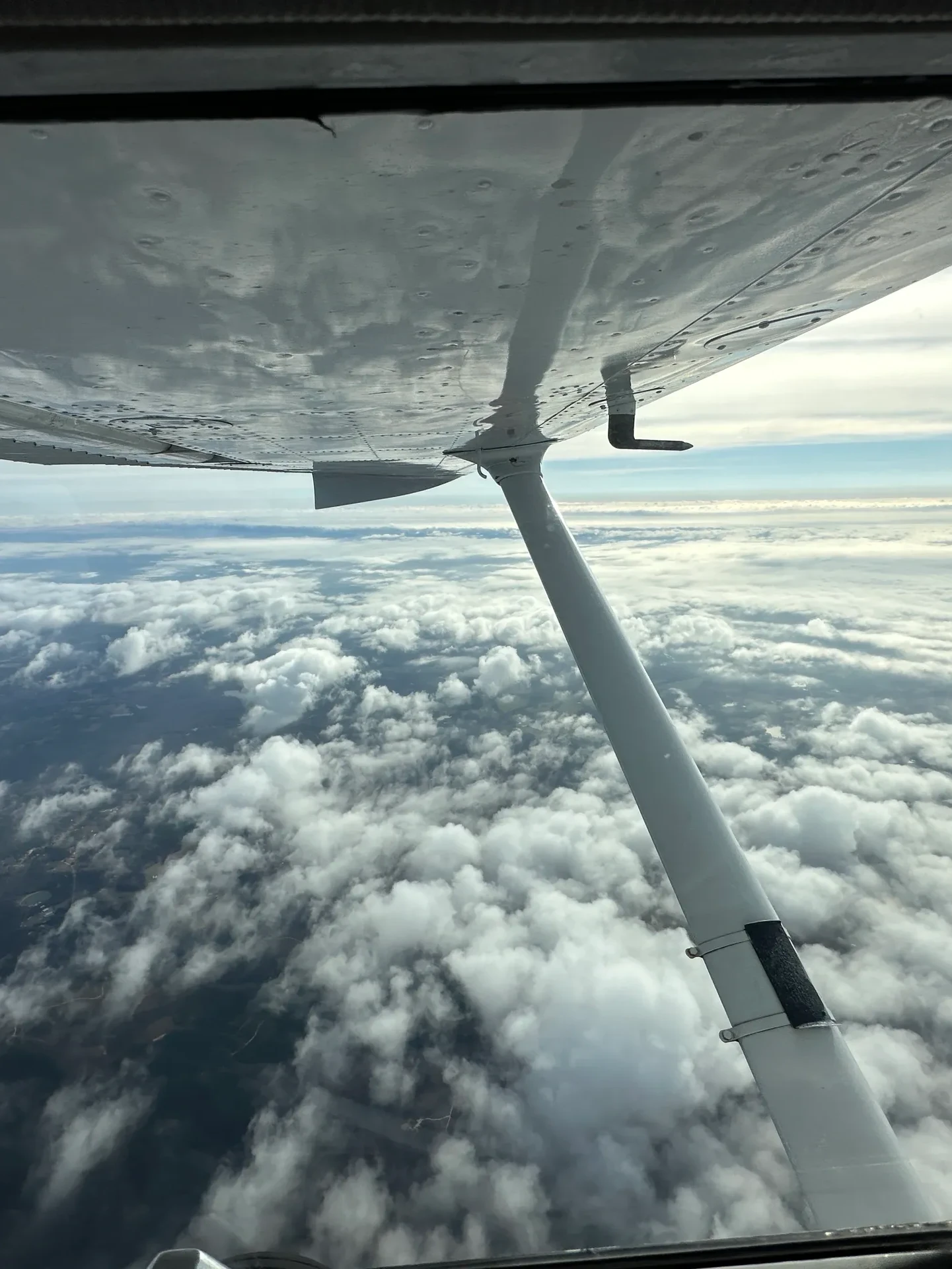 flying cessna over clouds Opelika, Alabama 