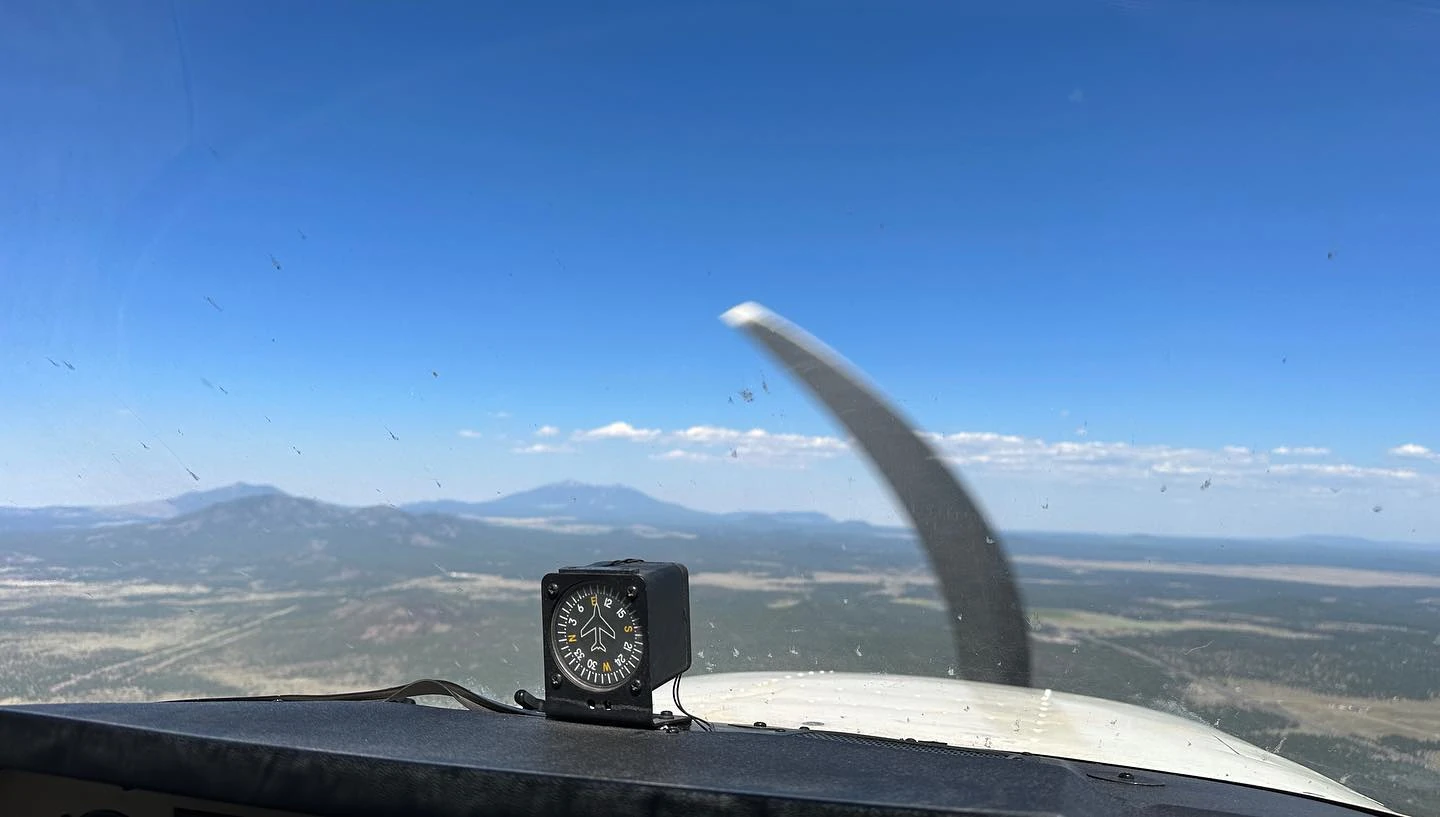 View over the propeller of a Cessna flying above east Alabama